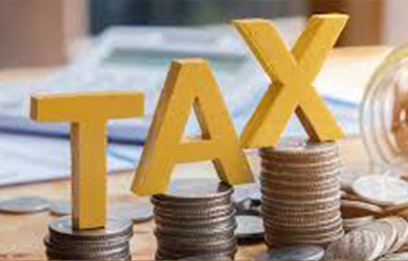 Tax letters balancing on pile of coins