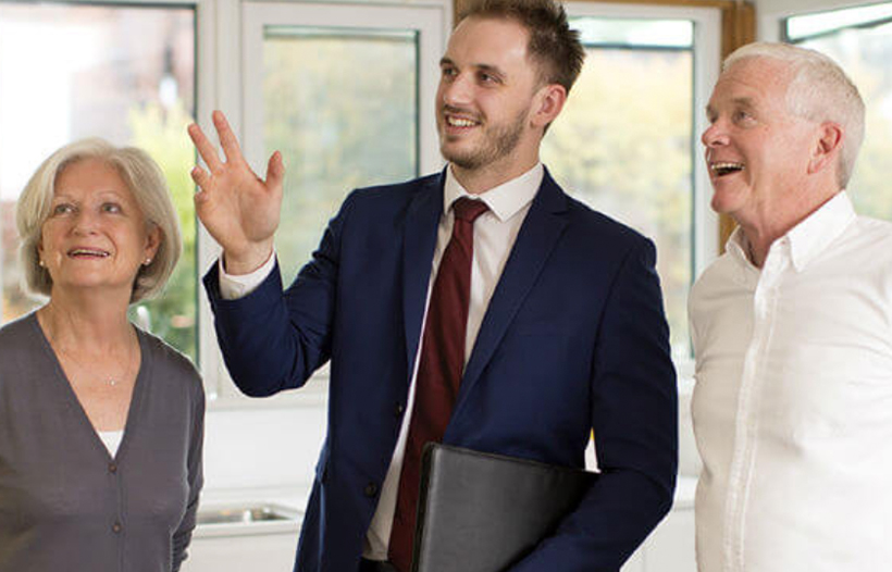 Estate Agent showing elderly couple around house