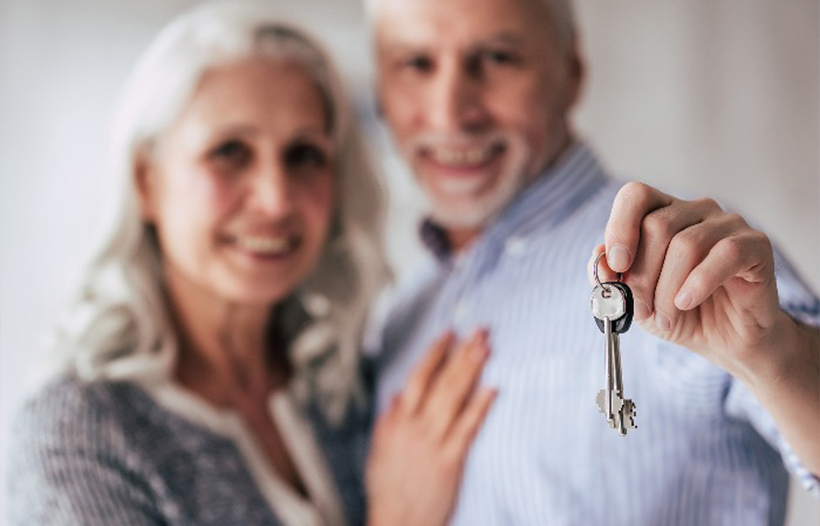 Elderly couple purchased a new property holding keys