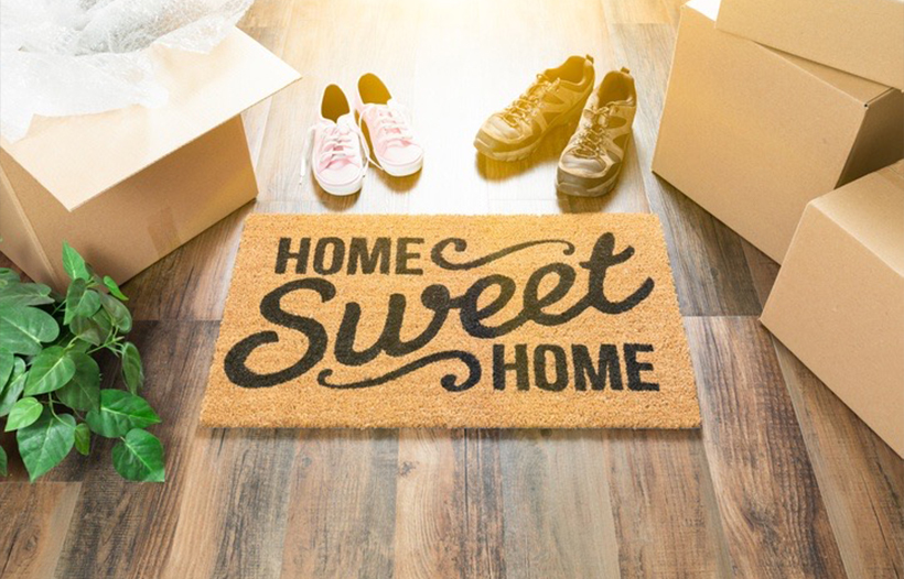 Home Sweet Home door mat with moving boxes