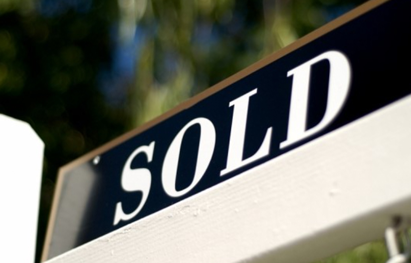 Sold banner on wooden fence