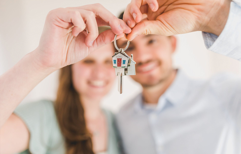 Couple holding new set of house keys