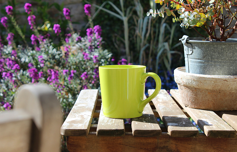 Green cup on garden table