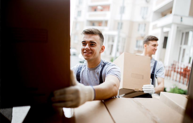 Removal men moving boxes