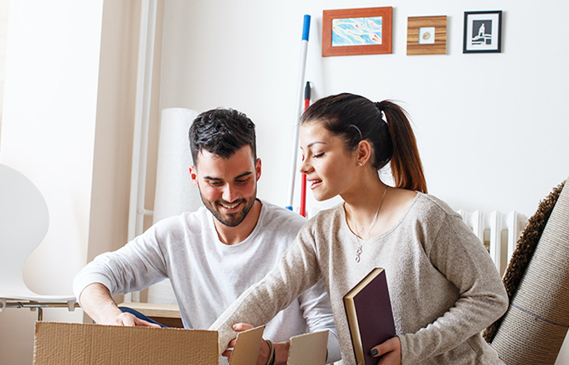 Couple unpacking moving boxes