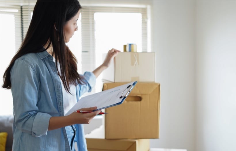 Lady looking at checklist for moving items