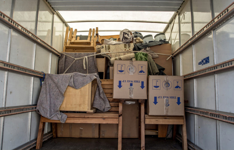 Back of removal van containing boxes and furniture