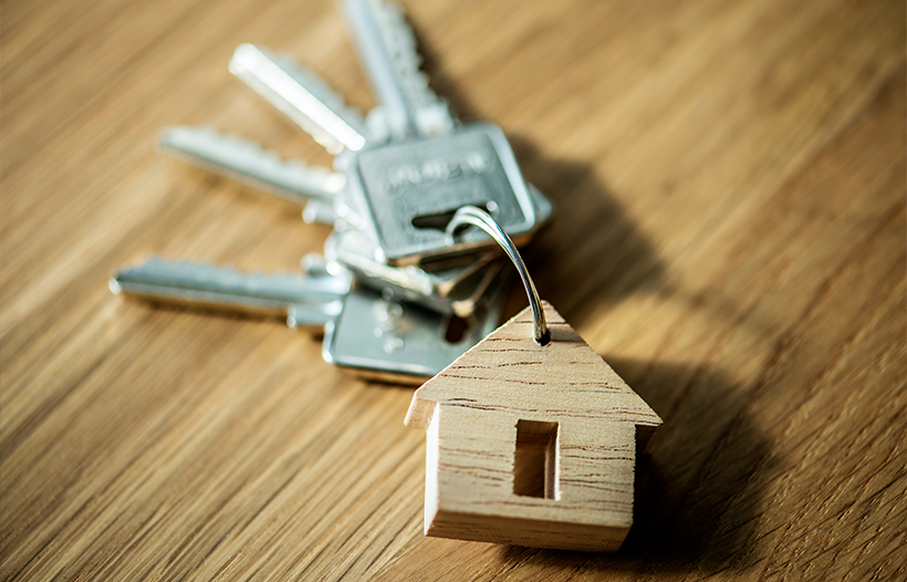 House keyring with keys on desk surface