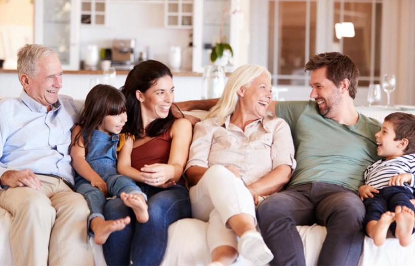 Family and grandparents sitting on couch