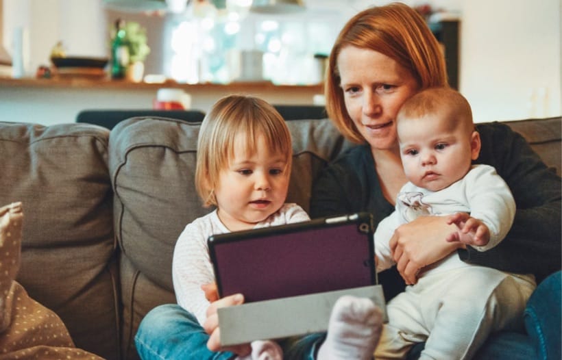 Mother and children looking at tablet