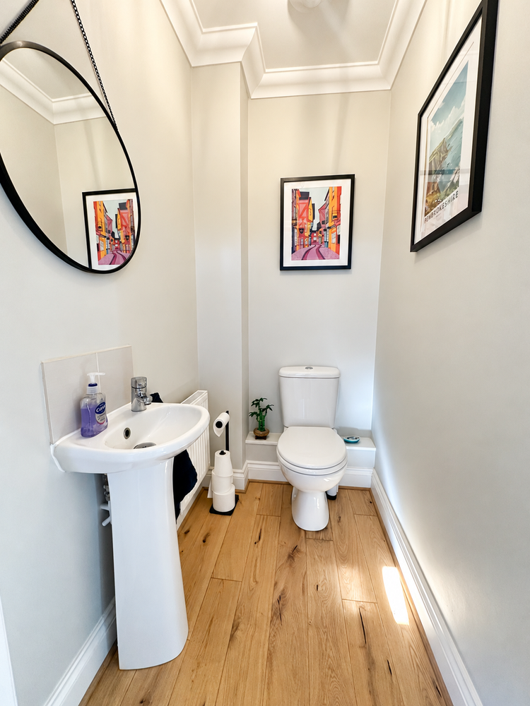 Brightened bathroom with closed toilet lid