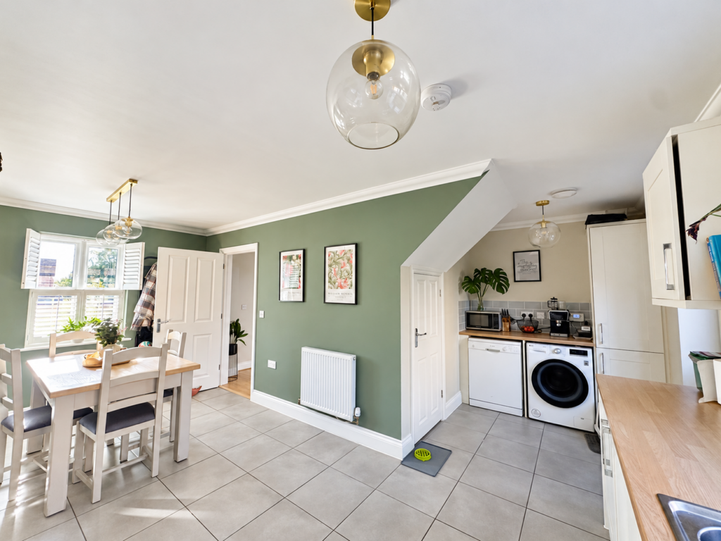 Sunlit sage kitchen with tiled floors