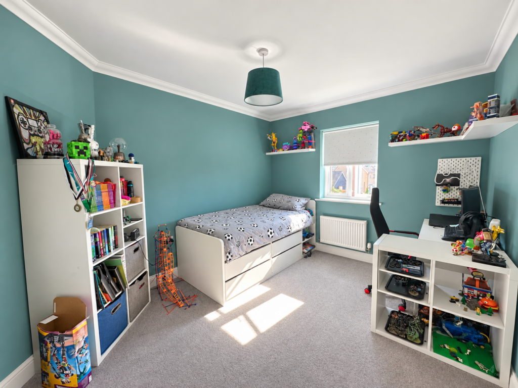 Brightened bedroom with tidy football bedding